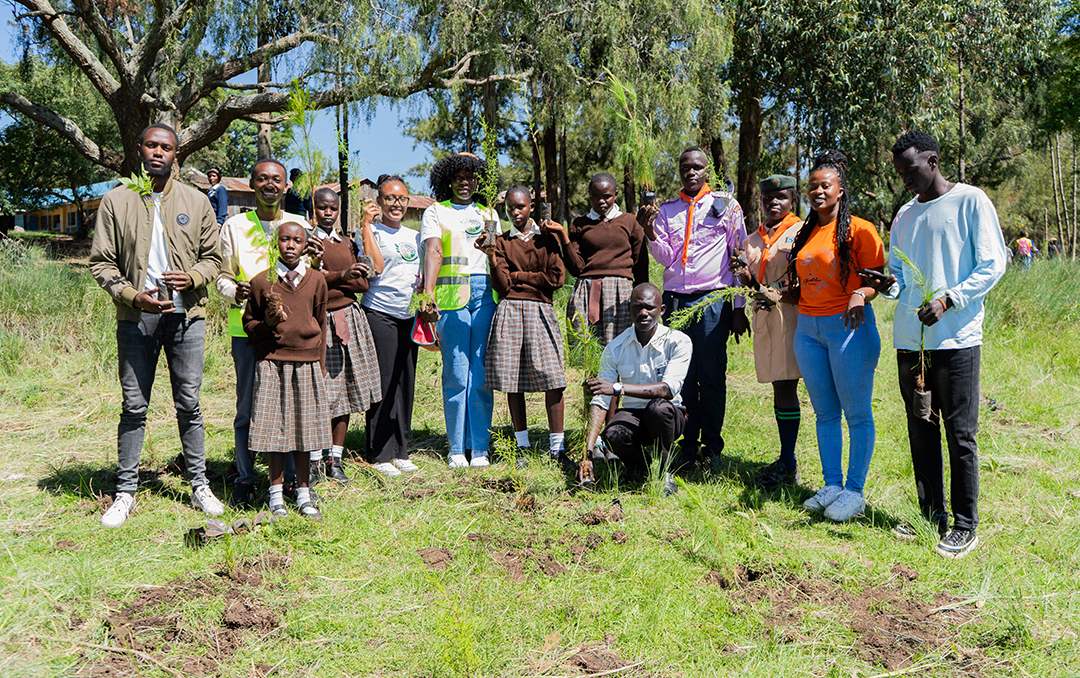 Students and community members participating in a Green Embassy Kenya tree-growing activity